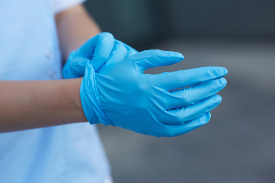 woman doctor wears medical gloves