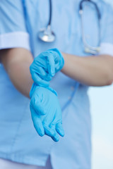 woman doctor wears medical gloves