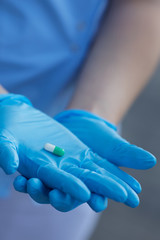 female doctor holding medicine capsules