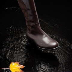 brown female boot splashing water