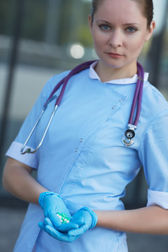 female doctor holding medicine capsules