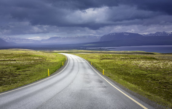 Curved asphalt road in high mountains of Iceland