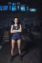 sexy soldier woman on factory ruins