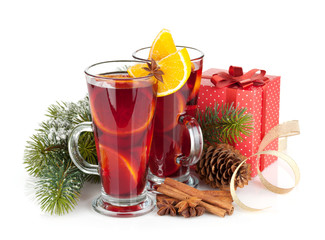 Christmas mulled wine with spices, gift box and snowy fir tree