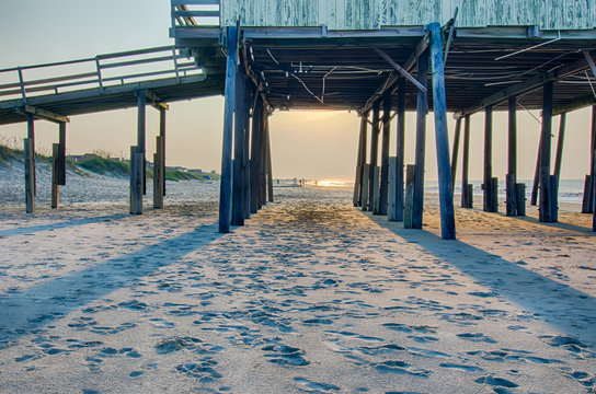looking under pier towards sandy beach at avon north carolina