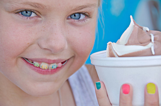 Girl with orthodontic smile and ice cream