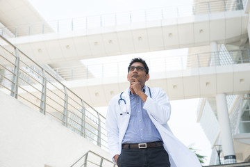 indian male doctor thinking on hospital background