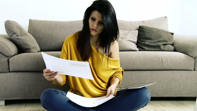 Woman reading bills getting angry