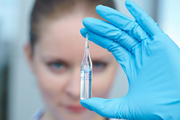 female doctor holding a vial