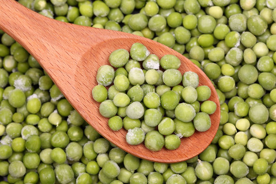 Frozen Green Peas In A Wooden Spoon