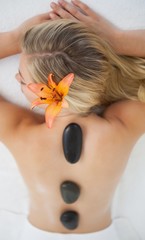 Beautiful blonde enjoying a hot stone massage