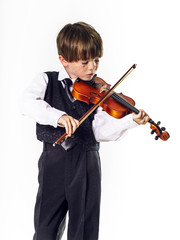 Red-haired preschooler boy with violin