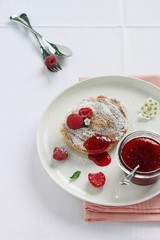 Delicious homemade pancakes with raspberry and jam