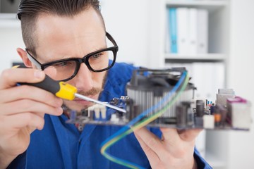 Computer engineer working on cpu with screwdriver