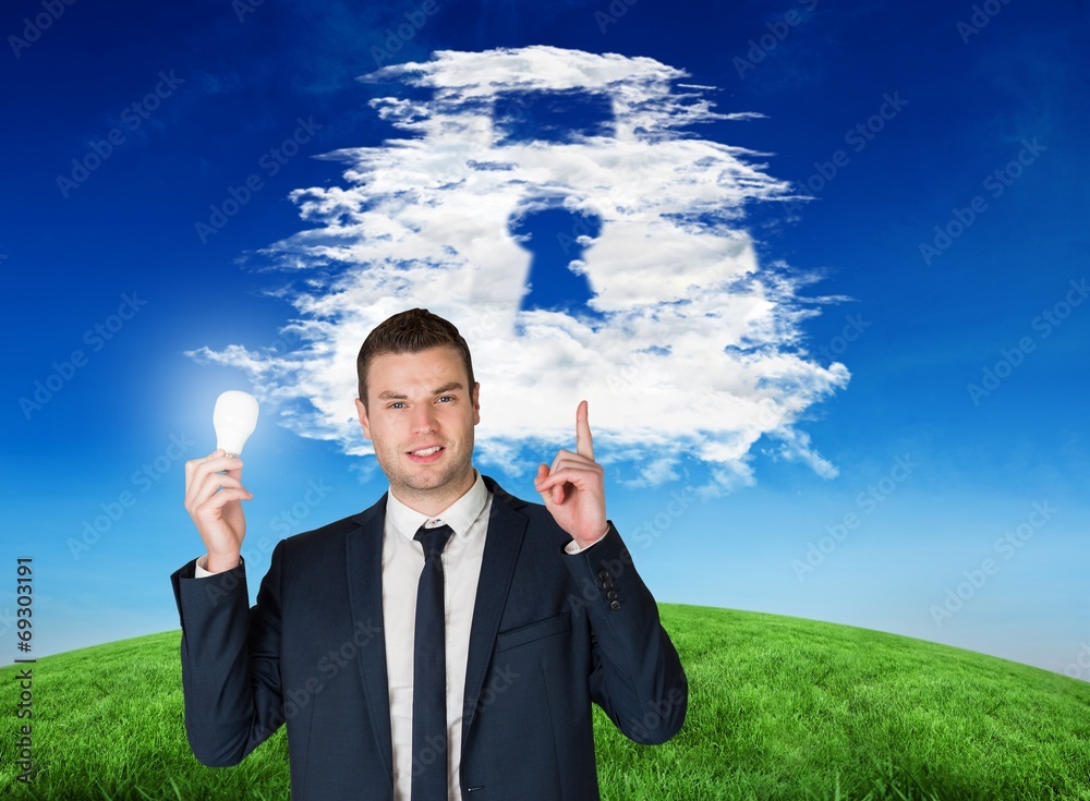 Aufkleber composite image of businessman holding light bulb and pointing
