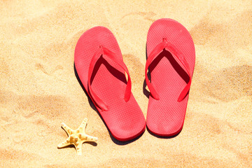 Fototapeta na wymiar Flip-flops on a sand