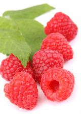 raspberries with leaves on white background