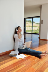 relaxed young woman at home working on laptop