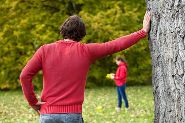 Man observing his girlfriend in park