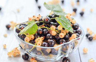 Fruits white black currants saucer wooden table Summer harvest