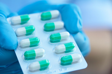 female doctor holding medicine capsules