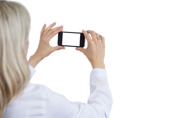 Woman taking photo with mobile phone