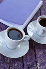 diary and cups of coffee