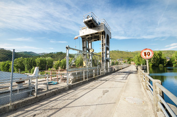 Road and cargo crane in a natural enviroment