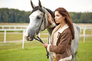 woman long hair kissing beautiful horse