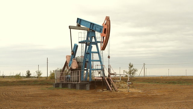 Work of oil pump jack on a oil field.