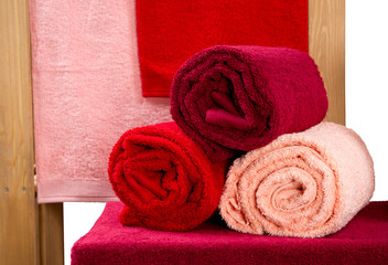 Obraz na płótnie Canvas stack of twisted terry towels on a shelf isolated on white
