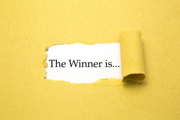 Torn brown paper with The winner is... text - 69321592