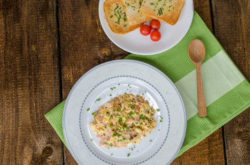 Scrambled eggs with chive and bacon, toast with herbs