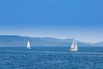 Fototapeta premium Two sailboats sailing on the Adriatic Sea in Croatia