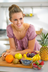 Portrait of smiling young housewife with fruits
