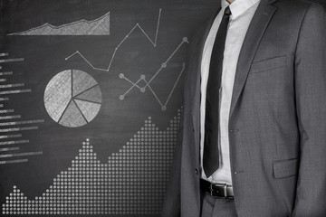 Diagrams and Businessman on Blackboard