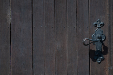 doorknob on the right and brown wooden door