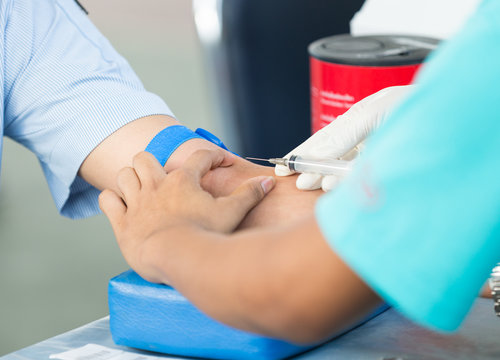 Nurse collecting a blood from a patient
