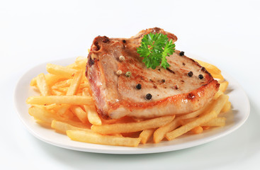 Pan fried pork chop with fries