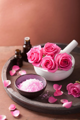 spa set with rose flowers mortar essential oils salt