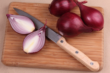 Onions and knife on cutting board