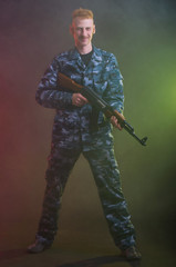 Man in camouflage clothing with a gun