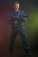 Man in camouflage clothing with a gun