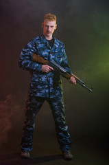 Man in camouflage clothing with a gun