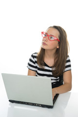 Serious young girl working at a laptop computer