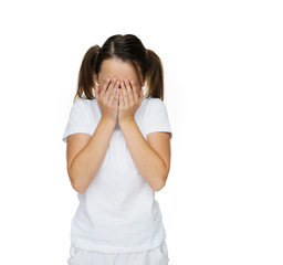 Young girl covering her face with her hands