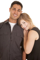 couple dark outfits her head on his shoulder