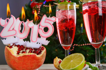 Two glasses with red champagne and candles 2015