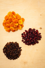 Dried fruits raisins apricots cranberries on table