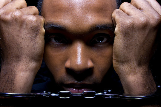 close up portrait of hand cuffed black man